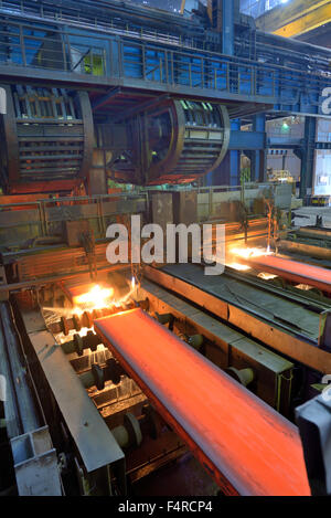 cut hot steel on conveyor inside of steel plant Stock Photo