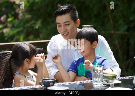 Happy family in the afternoon tea Stock Photo