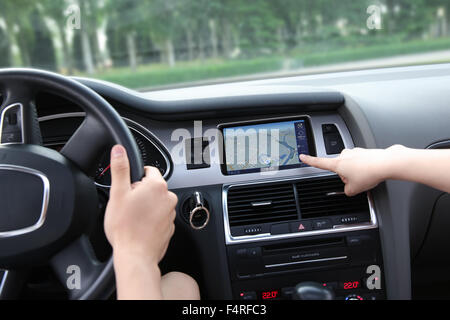 The young couple driving using the navigator Stock Photo