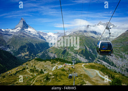 Cable cars sour past Matterhorn peak. July, 2105. Matterhorn, Switzerland. Stock Photo