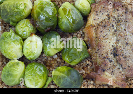 Fried pork cutlets with brussels sprouts and buckwheat in a lunch box. Stock Photo