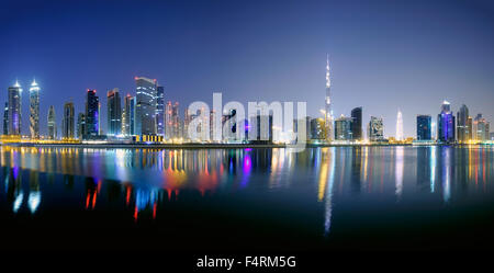 Night view of Burj Khalifa and Creek at new Business Bay district of  Dubai United Arab Emirates