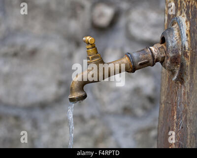 Dripping, drooping, leaking old tap. Stock Photo