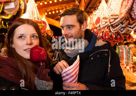 couple with sweets on christmas market Stock Photo