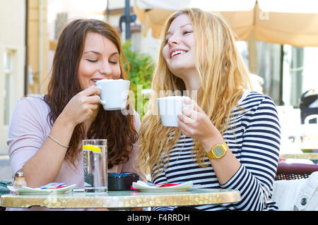 Two happy girls drinking coffee Stock Photo