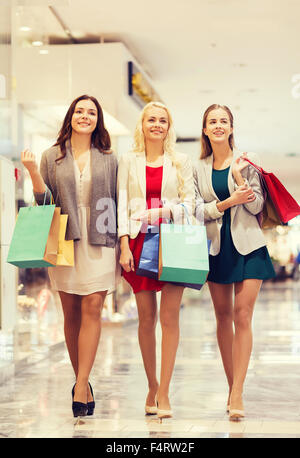 happy young women with shopping bags in mall Stock Photo