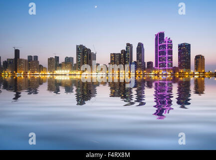 Evening skyline view of modern high-rise apartment buildings on Corniche in Sharjah United Arab Emirates Stock Photo