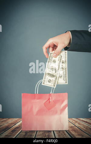 Composite image of hand holding hundred dollar bills Stock Photo