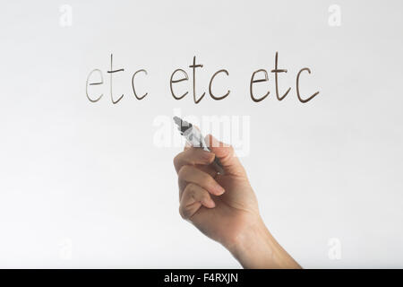 etc etc etc written in black marker on glass Stock Photo