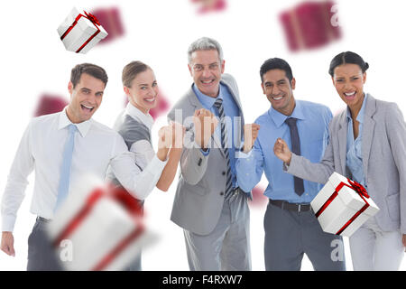 Composite image of portrait of successful business people clenching fists Stock Photo