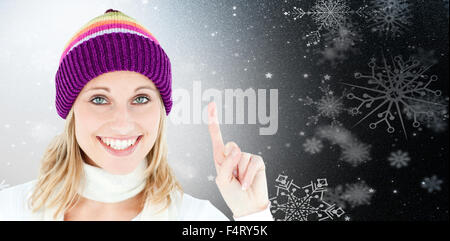 Composite image of positive woman showing up smiling at the camera against white background Stock Photo