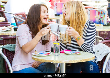 Two girls having fun in a cafe Stock Photo
