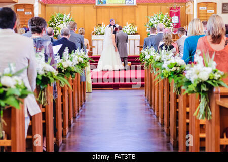 A bride and groom take their vows at a wedding Stock Photo