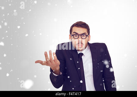 Composite image of doubtful businessman with glasses gesturing Stock Photo