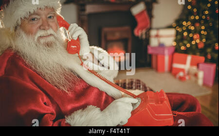 Smiling santa making a phone call Stock Photo