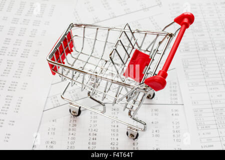 Empty shopping cart on a financial report Stock Photo