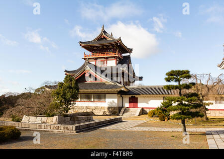 Japan, Kyoto, Fushimi castle, also known as Momoyama castle. Built as a Castle Entertainment Park in 1964. Castle yagura, turret with Japanese trees. Stock Photo