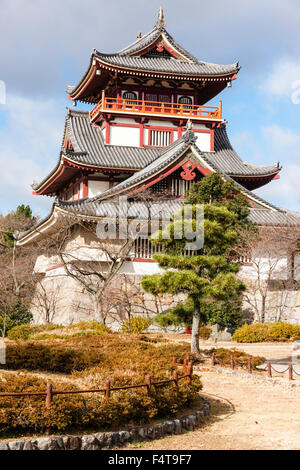 Japan, Kyoto, Fushimi castle, also known as Momoyama castle. Built as a Castle Entertainment Park in 1964. Castle yagura, turret with Japanese trees. Stock Photo