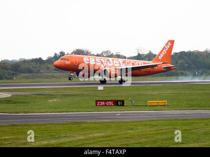 The All Orange Colours of EasyJet Airlines Airbus A320-214 Airliner G-EZUI Landing at Manchester Airport England United Kingdom Stock Photo