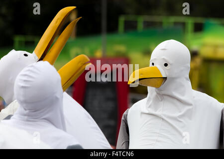 A group of people dressed as seagulls gather at a music festival in Somerset, UK Stock Photo