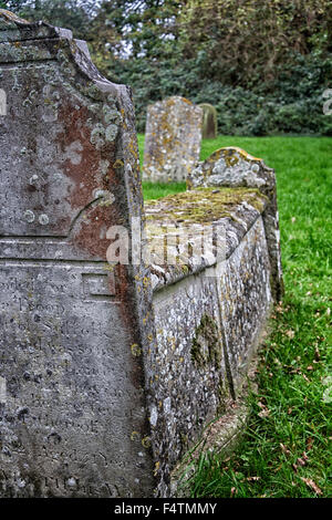 Ancient grave headstones in an English village churchyard, Suffolk, UK Stock Photo