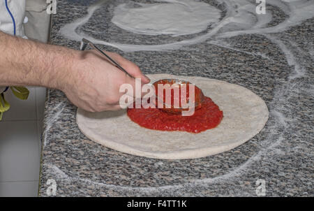 Pizza chef at work preparing pizzas to be cooked Stock Photo