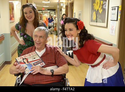 Albuquerque, NM, USA. 21st Oct, 2015. 10222015---Pin-Ups for Vets ambassadors Julia Reed Nichols (CQ) left, and Gina Elise (CQ) right, deliver their 2016 calendar to Army veteran Carlton Aldridge (CQ) during a visit to the VA Hospital in Albuquerque. Pin-Ups for Vets is nonprofit organization which raises money to support veterans in VA and Military hospitals nationwide, photographed on Thursday October 22, 2015. (Dean Hanson/Albuquerque Journal) © Dean Hanson/Albuquerque Journal/Albuquerque Journal/ZUMA Wire/Alamy Live News Stock Photo