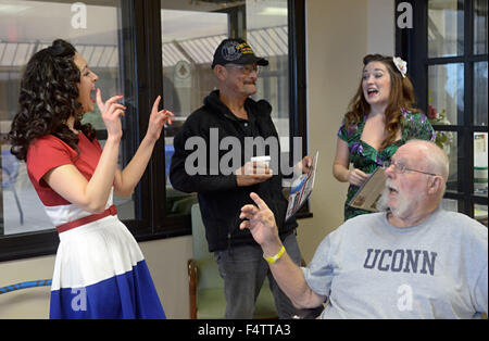 Albuquerque, NM, USA. 21st Oct, 2015. 10222015---Pin-Ups for Vets ambassadors Gina Elise (CQ) left and Julia Reed Nichols (CQ) right, deliver their 2016 calendar to Army veteran Frank Cordova (CQ) top, and Air Force veteran Stephen Mahnke (CQ) during a visit to the VA Hospital in Albuquerque. Pin-Ups for Vets is nonprofit organization which raises money to support veterans in VA and Military hospitals nationwide, photographed on Thursday October 22, 2015. (Dean Hanson/Albuquerque Journal) © Dean Hanson/Albuquerque Journal/Albuquerque Journal/ZUMA Wire/Alamy Live News Stock Photo