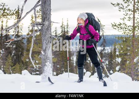 Young woman skiing with a backpack in Lapland. Stock Photo