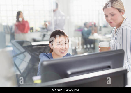 Businesswomen working at computer in office Stock Photo