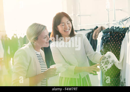 Fashion designers examining cuff detail on blouse Stock Photo