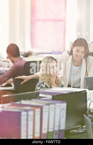 Fashion designers working at desk in office Stock Photo