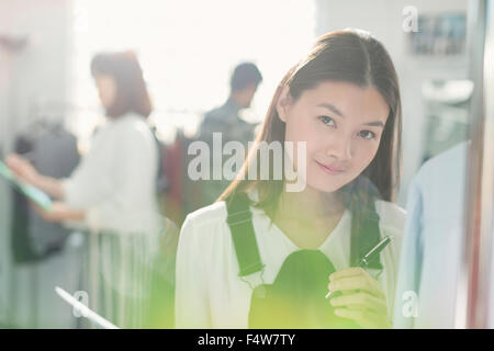 Portrait smiling fashion designer in office Stock Photo