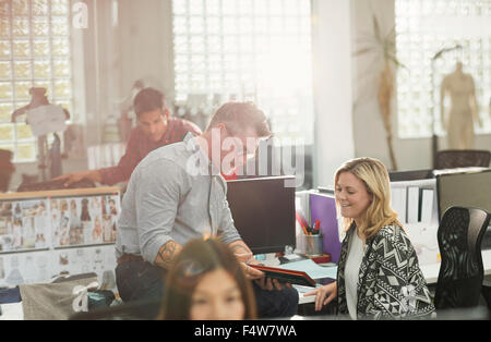 Fashion designers using digital tablet in office Stock Photo