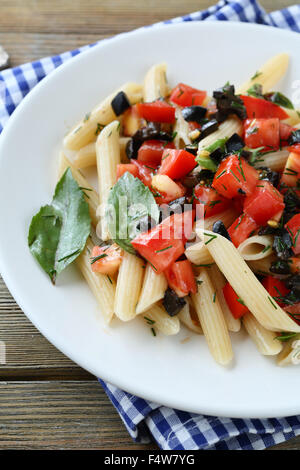 penne with tomato and olive sauce on plate Stock Photo