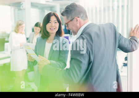 Business people discussing paperwork in office Stock Photo