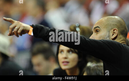 Munich, Germany. 22nd Oct, 2015. Head coach of soccer club FC Bayern Munich Pep Guardiola and his wife Cristina Serra watch the basketball Euro League group A match between FC Bayern Munich and Chimki Moscow at the Audi Dome in Munich, Germany, 22 October 2015. Photo: Andreas Gebert/dpa/Alamy Live News Stock Photo