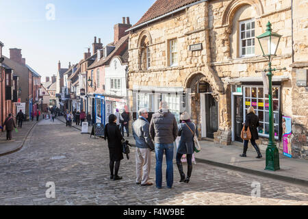 Looking down the old cobbled street of Steep Hill, Lincoln, England, UK. Jews House is on the right. Stock Photo