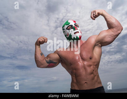 Large male muscular Wrestler with Mexican flag wrestling mask Stock Photo