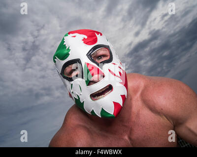 Large male muscular Wrestler with Mexican flag wrestling mask Stock Photo