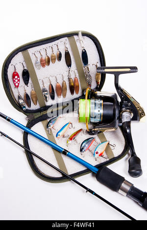 Fishing rod and lures with bag for baits on white. Fishing lures, wobblers in bag for fishing baits. Stock Photo