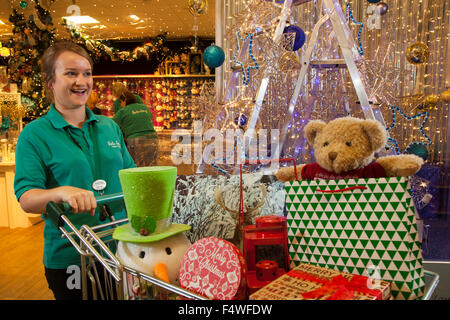 Barton Grange, Garstang, UK. 23rd October, 2015. The famous Barton Grange Garden Centre Xmas displays.  Sales assistant Georgina Lawson putting the finishing touches to the Barton Grange Garden centre's Christmas display.  Display Manager, David Fawcett-Ropner, who has worked at the centre for the last ten years, has been busy with nine of his staff making preparations for this years launch.  David started the on site build on the 7th Sept ready for today's opening day, just in time for the Autumn half time. Credit:  Cernan Elias/Ģ����ý Live News Stock Photo