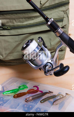 Fishing rod and reel with silicone baits. Fishing silicone lures on the box. Stock Photo