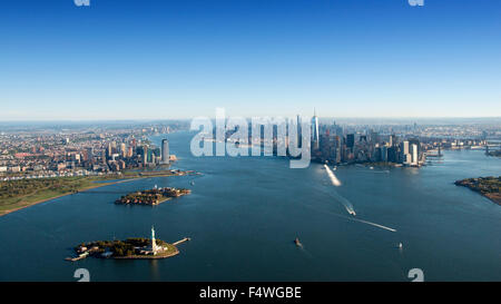 Aerial shot from a helicopter, looking towards Liberty Island, Jersey City and Manhattan, New York USA Stock Photo