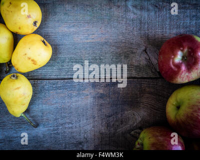 pears and apples on wooden weathering background Stock Photo