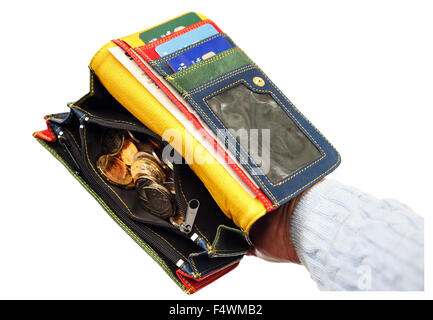 A person's woman's hand holding a purse open with money sterling coins inside isolated on a plain white background. England, UK, Britain Stock Photo