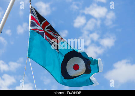 RAF Ensign Flag flying at full mast against blue sky. French flag in ...