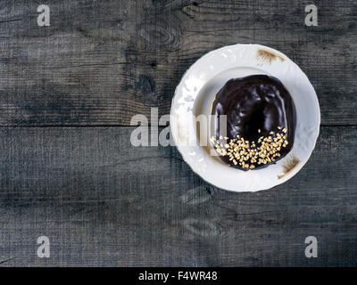 Donuts on wooden background. Retro style photo Stock Photo