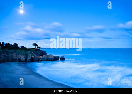 The coast at Pornic before sunrise in the moonlight Stock Photo