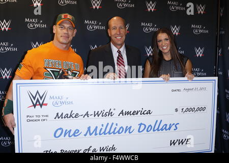 Make-A-Wish Foundation celebrates WWE superstar John Cena's 500th granted wish at Dave & Busters Times Square. WWE also presented the foundation with a check for $ 1 million dollars.  Featuring: John Cena, David Williams, Stephanie McMahon Where: New York Stock Photo